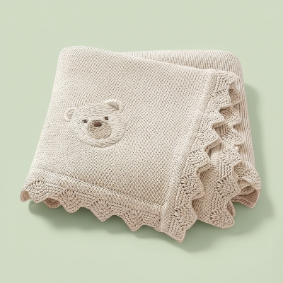 Couverture bebe tricot beige ours brodé fond vert pale