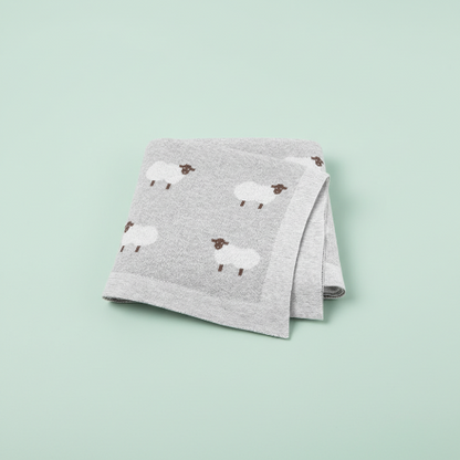 Couverture bebe tricot grise motif moutons fond vert pâle